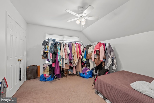 bedroom with ceiling fan, carpet floors, and vaulted ceiling