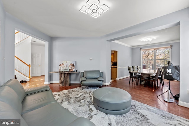 living room featuring wood-type flooring and ornamental molding