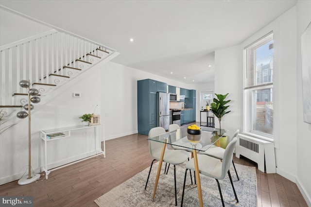 dining room with radiator and dark wood-type flooring