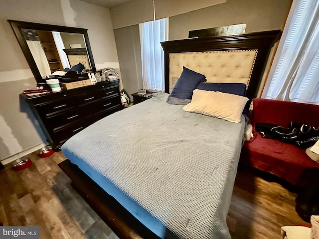 bedroom with dark hardwood / wood-style flooring