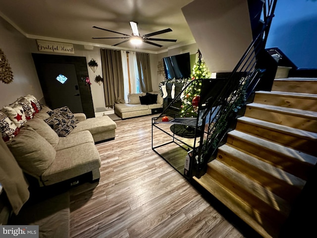 living room with ceiling fan, ornamental molding, and hardwood / wood-style flooring