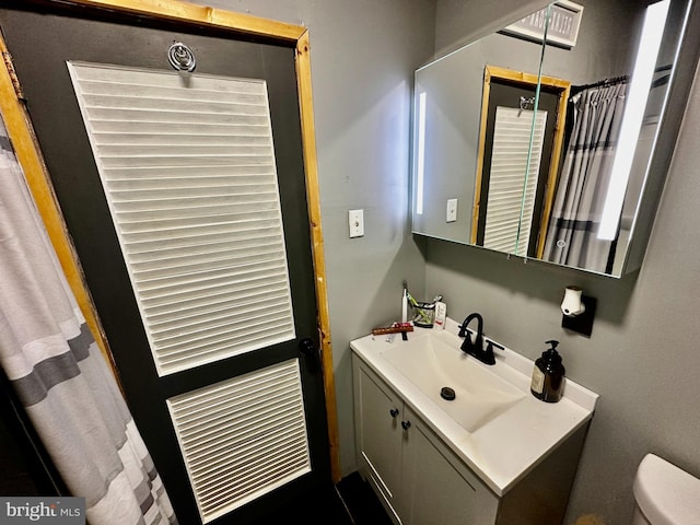 bathroom with vanity and toilet