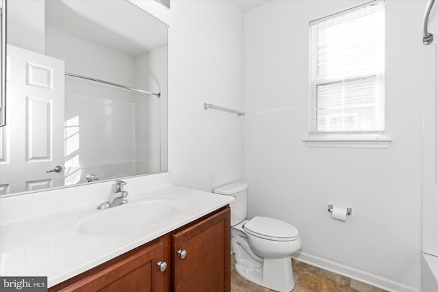 bathroom with vanity, toilet, and a wealth of natural light