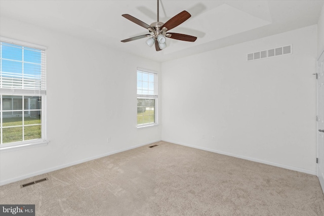 carpeted spare room featuring ceiling fan