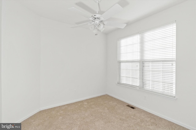 unfurnished room featuring ceiling fan and light carpet