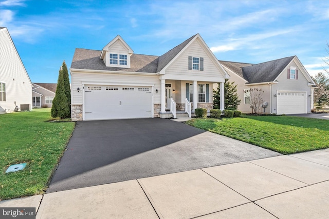 view of front of house featuring a porch, central AC, a front lawn, and a garage