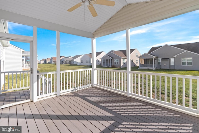 unfurnished sunroom with ceiling fan, lofted ceiling, and a wealth of natural light