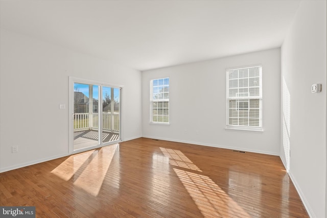 empty room with hardwood / wood-style floors