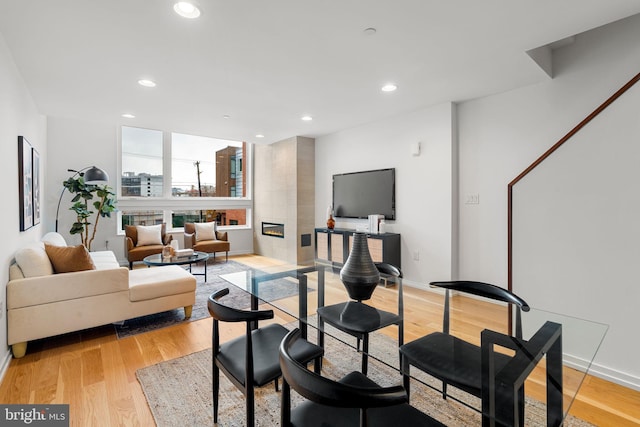 dining area featuring a fireplace and light hardwood / wood-style flooring