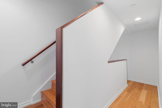 staircase featuring wood-type flooring