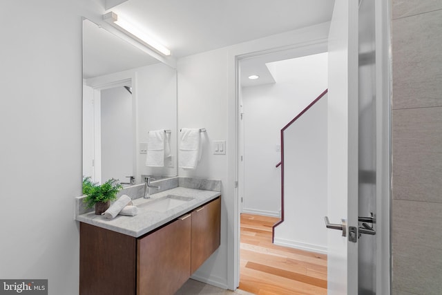 bathroom with hardwood / wood-style floors and vanity