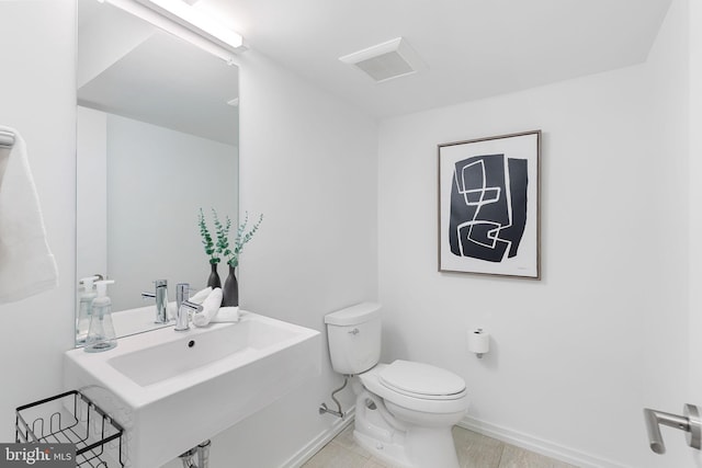 bathroom featuring tile patterned flooring and toilet