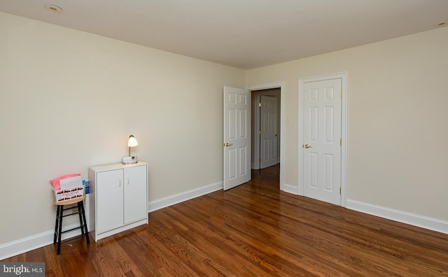 spare room with dark wood-type flooring