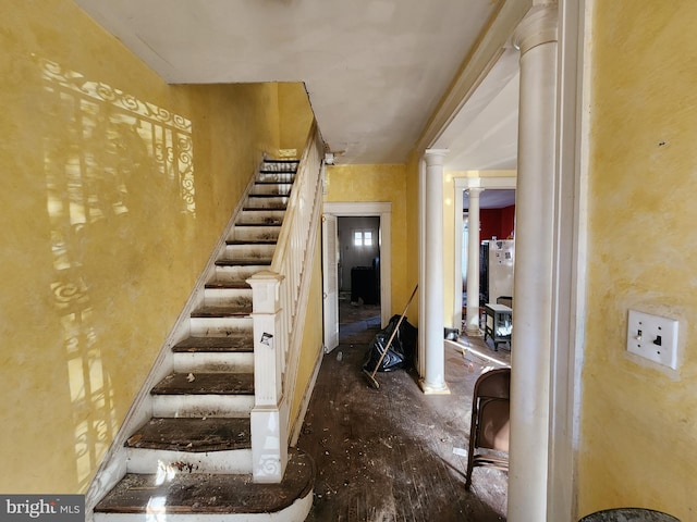 staircase with ornate columns