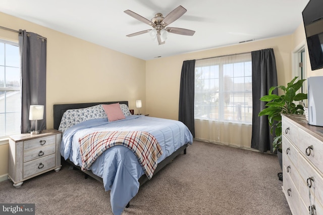 bedroom with ceiling fan and light carpet