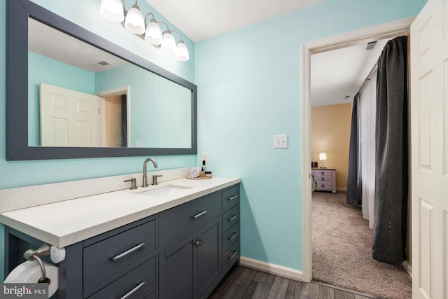 bathroom with hardwood / wood-style floors and vanity