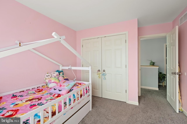 bedroom with light carpet and a closet