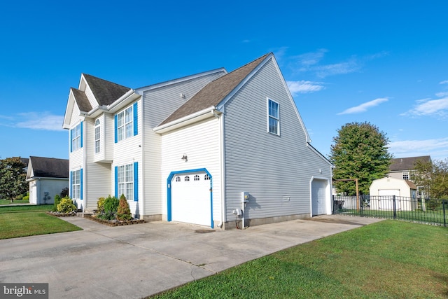 view of side of property featuring a yard and a garage