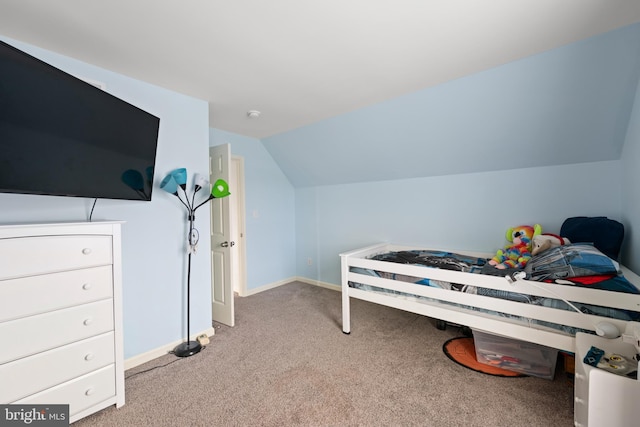 bedroom with light colored carpet and vaulted ceiling