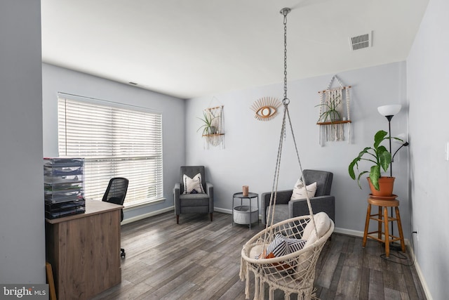 office space with dark wood-type flooring and a healthy amount of sunlight