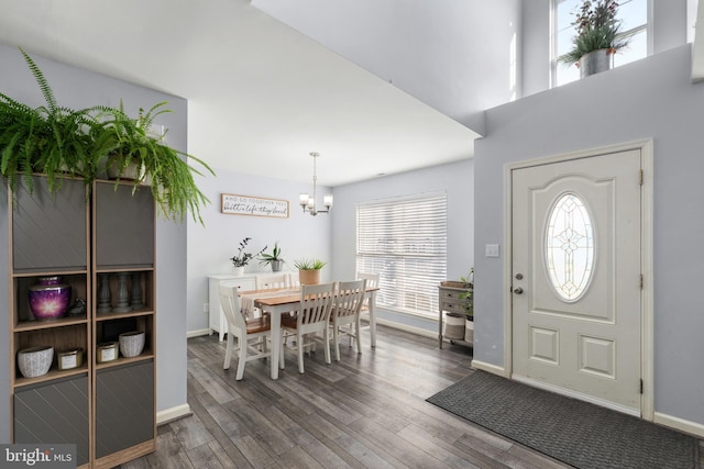 entrance foyer with an inviting chandelier and dark wood-type flooring