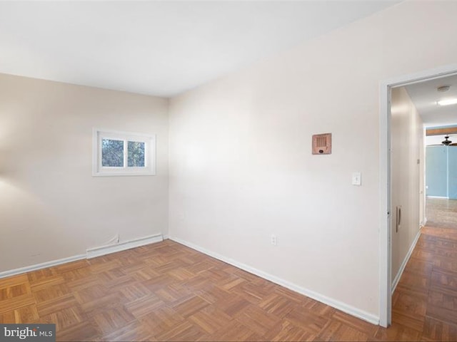 empty room featuring ceiling fan and parquet floors