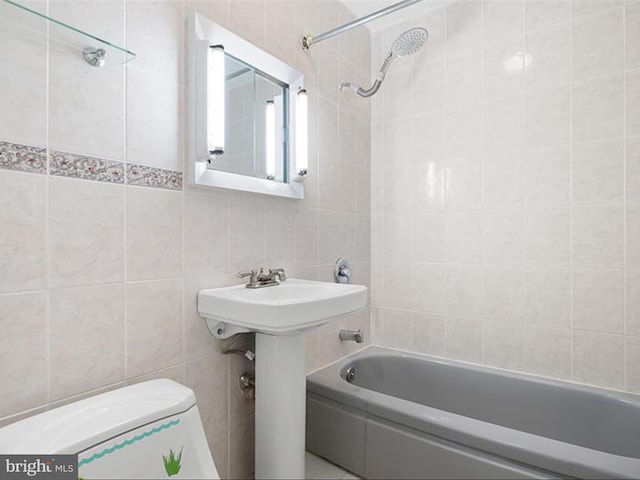 full bathroom featuring shower / tub combination, sink, tile walls, and toilet