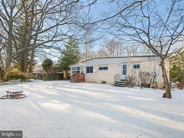 view of snow covered back of property