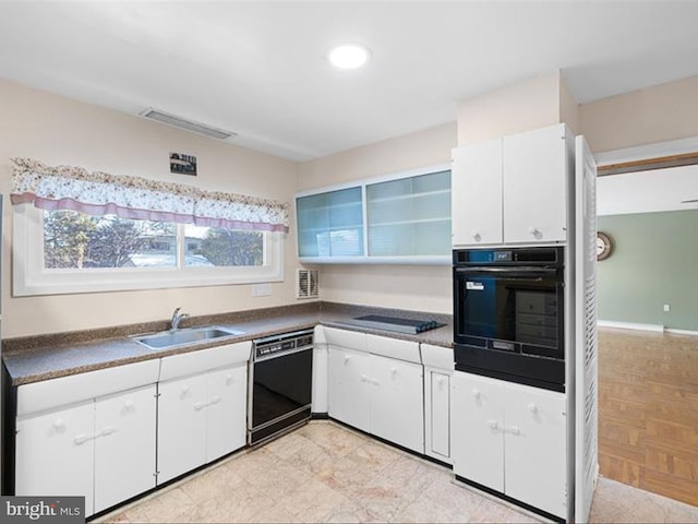 kitchen with black appliances, white cabinetry, and sink