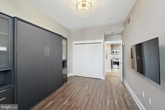 unfurnished bedroom featuring hardwood / wood-style floors