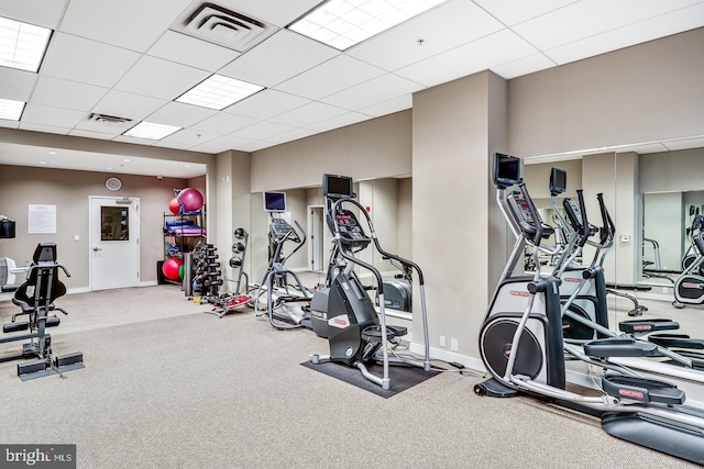 exercise room featuring carpet flooring and a drop ceiling