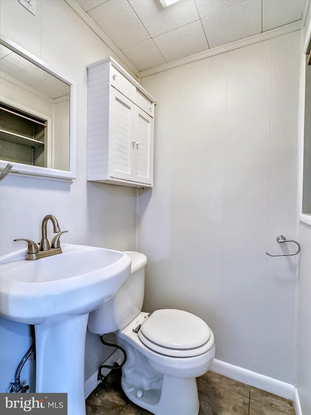 bathroom with toilet and ornamental molding