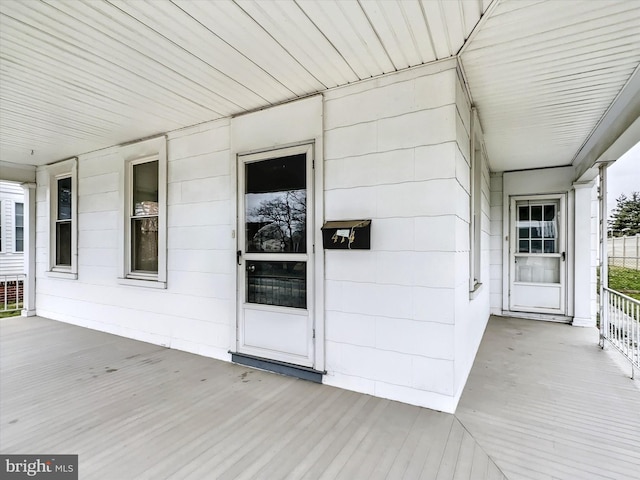 view of exterior entry with a porch