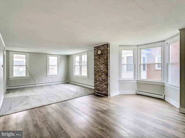 spare room with light hardwood / wood-style floors and a baseboard heating unit