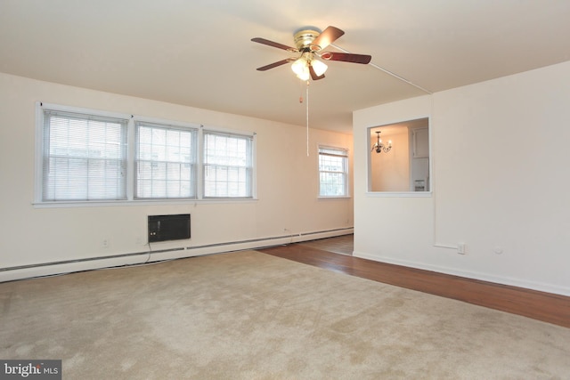 spare room with ceiling fan, a baseboard radiator, and hardwood / wood-style floors