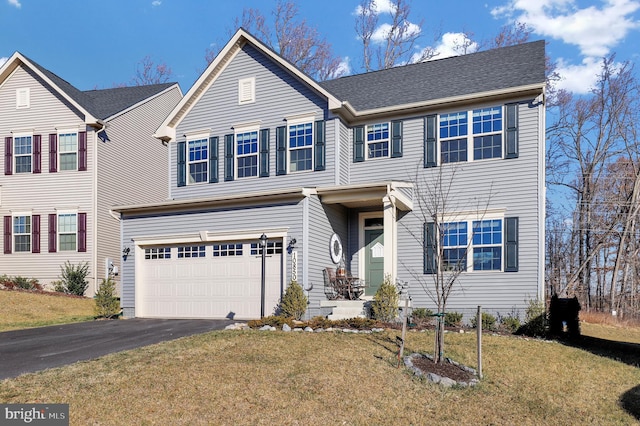 view of front facade featuring a garage and a front lawn