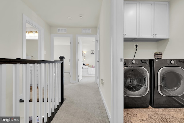 laundry area featuring washer and dryer and light colored carpet