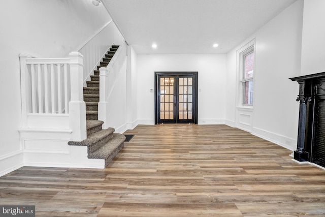 foyer entrance featuring light hardwood / wood-style flooring and french doors