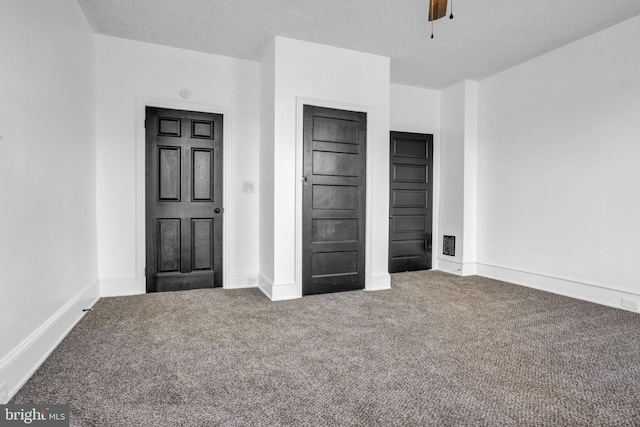 unfurnished bedroom featuring ceiling fan and carpet floors