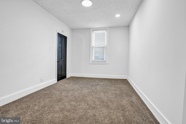 empty room featuring carpet floors and a textured ceiling