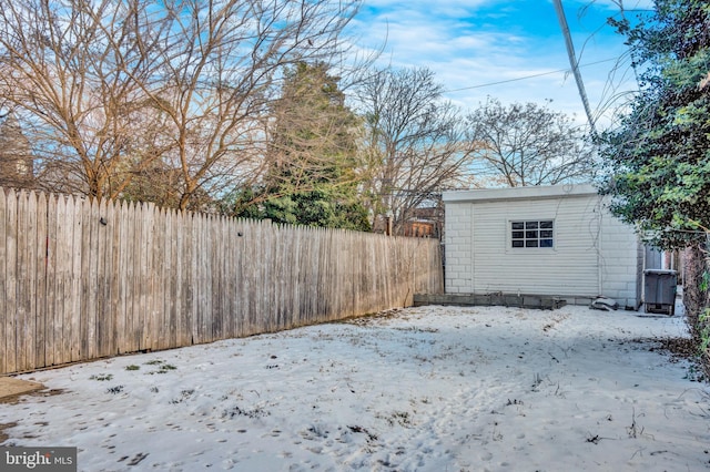 yard covered in snow with a shed