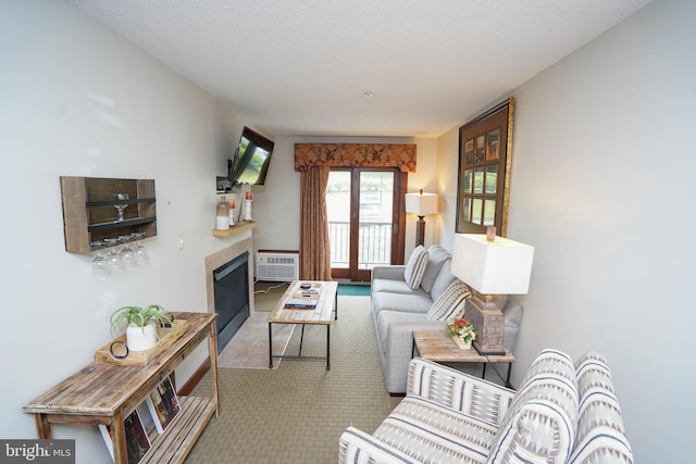 living room with a textured ceiling, an AC wall unit, and light carpet