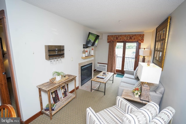 carpeted living room with a fireplace, a textured ceiling, and an AC wall unit