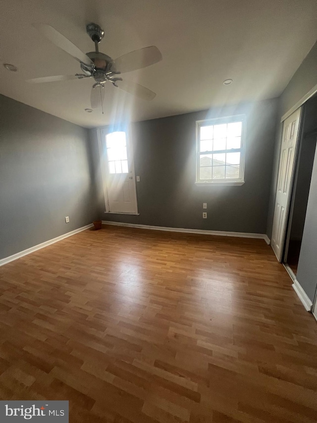 unfurnished room with hardwood / wood-style flooring, plenty of natural light, and ceiling fan