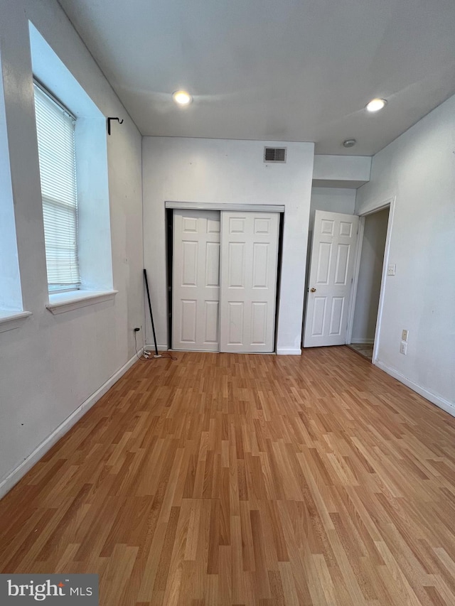 unfurnished bedroom featuring light wood-type flooring