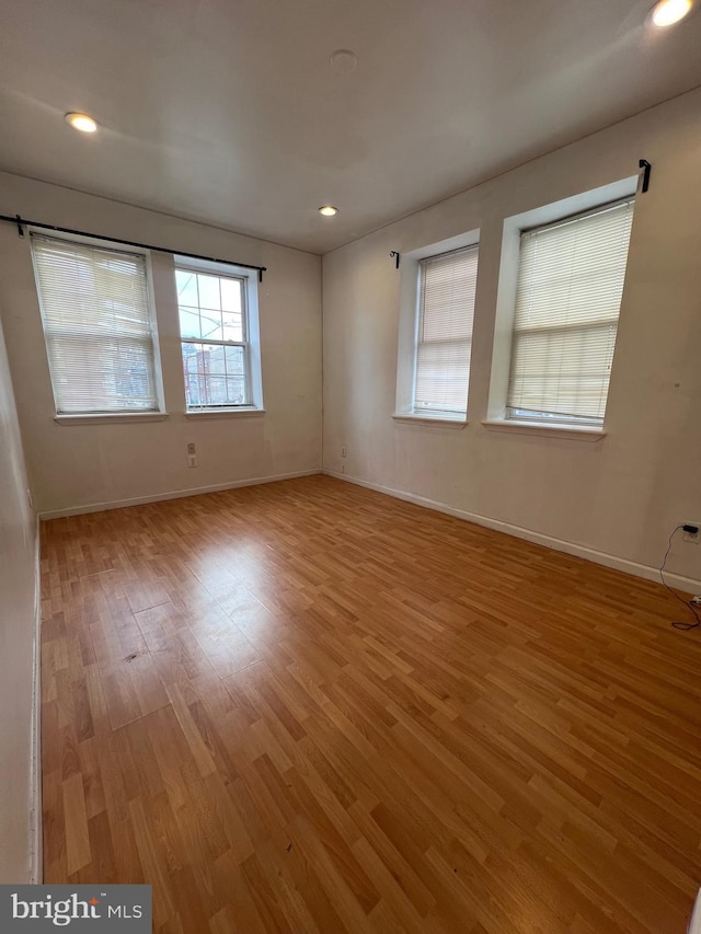 unfurnished room with light wood-type flooring