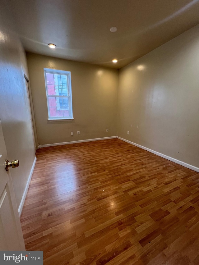 spare room with hardwood / wood-style floors