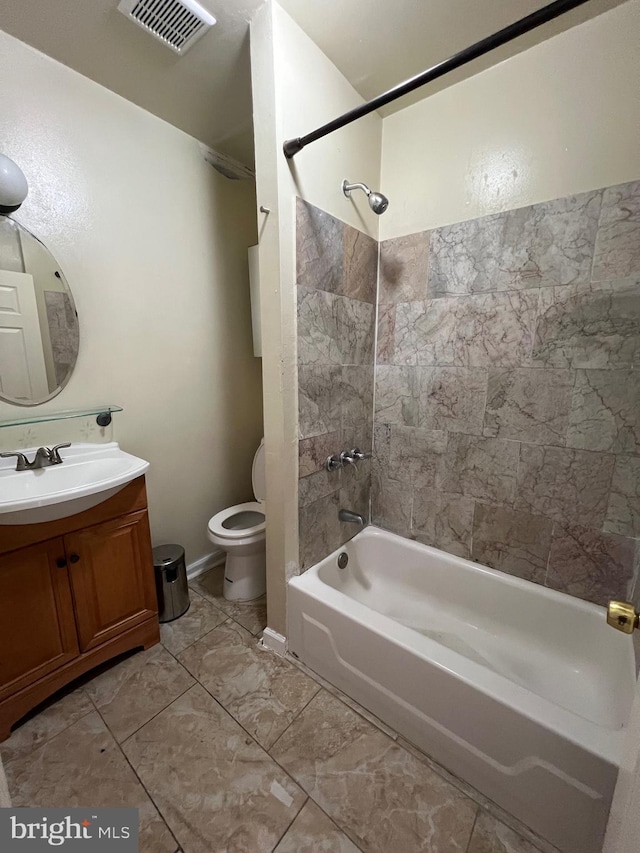 full bathroom with tiled shower / bath combo, toilet, and vanity