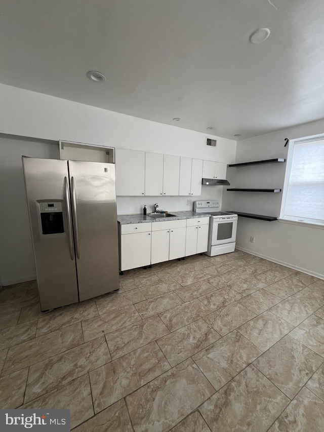 kitchen featuring stainless steel fridge, white electric range, white cabinets, and sink