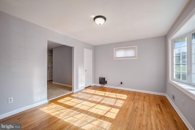 spare room with light hardwood / wood-style floors